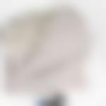 Folded gray wool plaid with white border and white pattern.